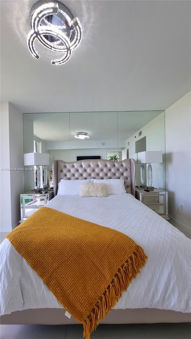 50 Biscayne Blvd Unit 1902, Miami, FL 33132 - bedroom with baseboards and a chandelier