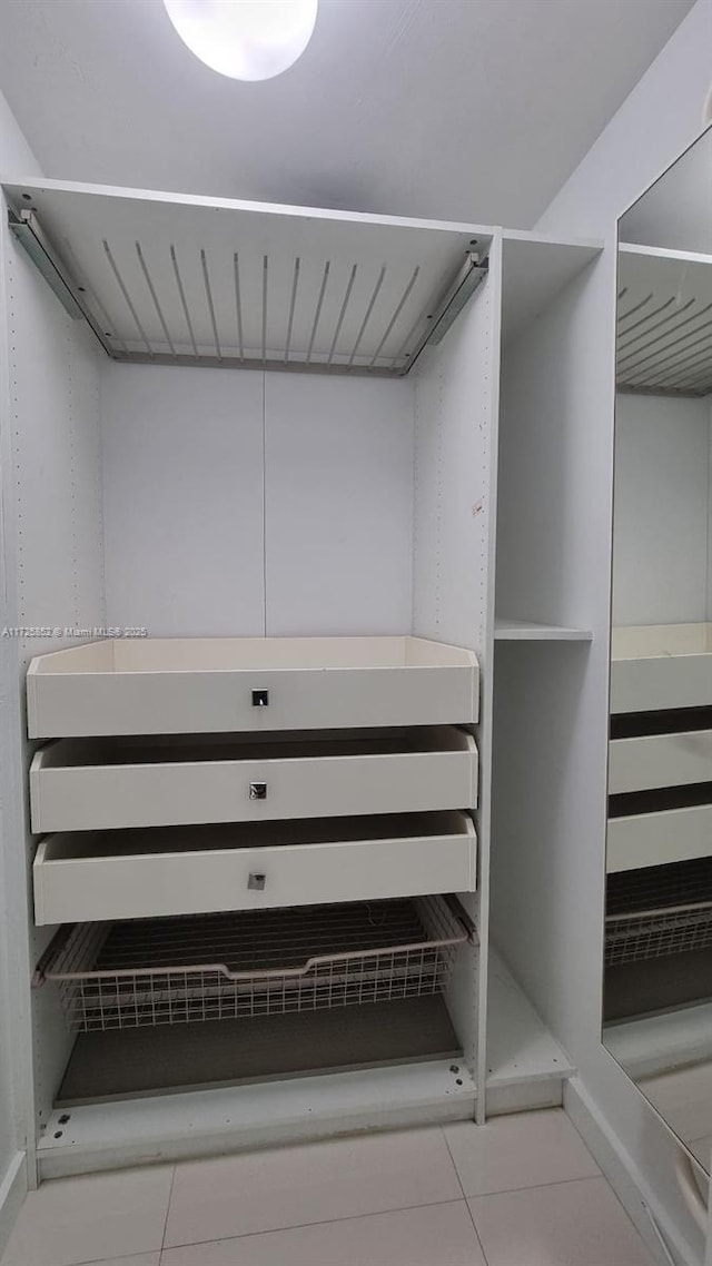 walk in closet featuring tile patterned flooring