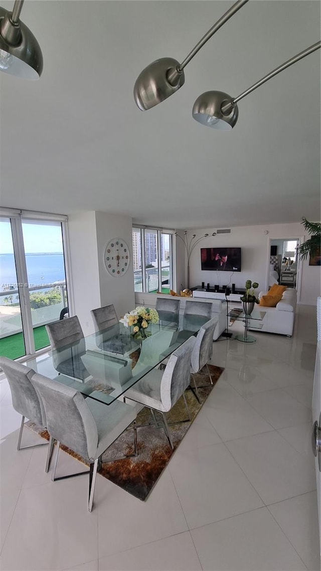 dining room with light tile patterned floors and plenty of natural light