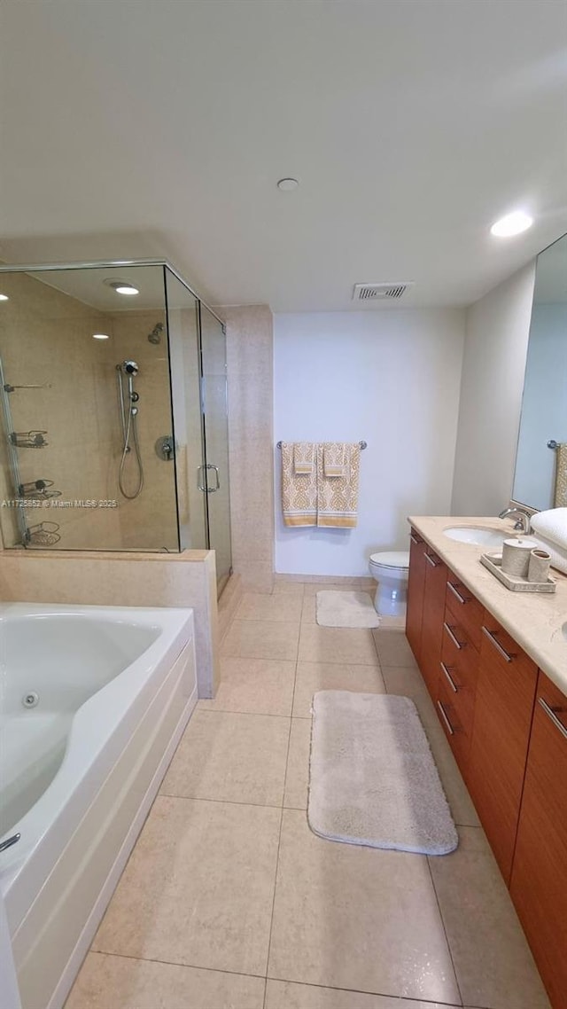 full bathroom featuring toilet, vanity, independent shower and bath, and tile patterned floors