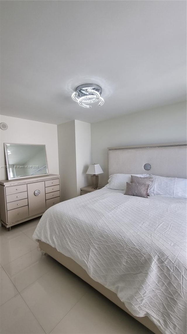 bedroom with light tile patterned floors