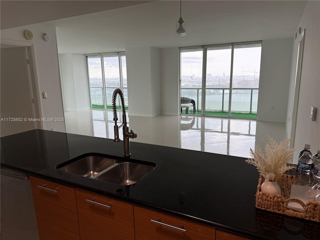50 Biscayne Blvd Unit 1902, Miami, FL 33132 - kitchen featuring a sink, dark countertops, brown cabinets, a water view, and pendant lighting