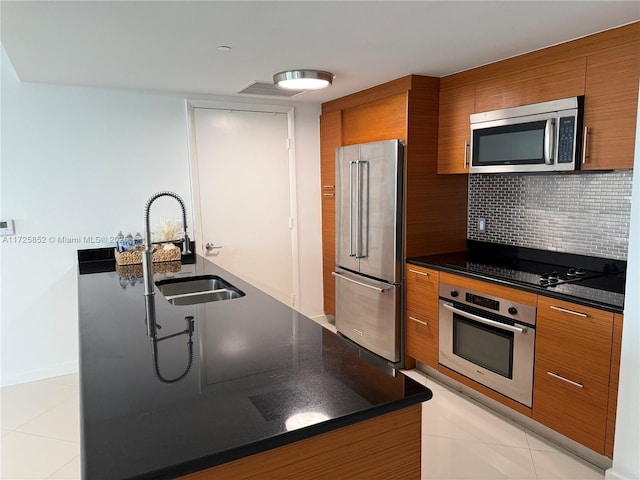 50 Biscayne Blvd Unit 1902, Miami, FL 33132 - kitchen featuring appliances with stainless steel finishes, brown cabinets, a sink, and dark countertops