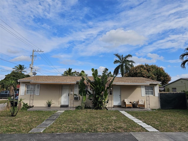 bungalow-style house with cooling unit and a front yard