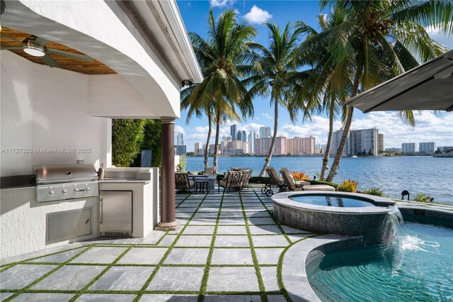 view of patio / terrace with a water view and a fire pit