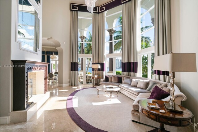 dining area with a raised ceiling, crown molding, and a notable chandelier