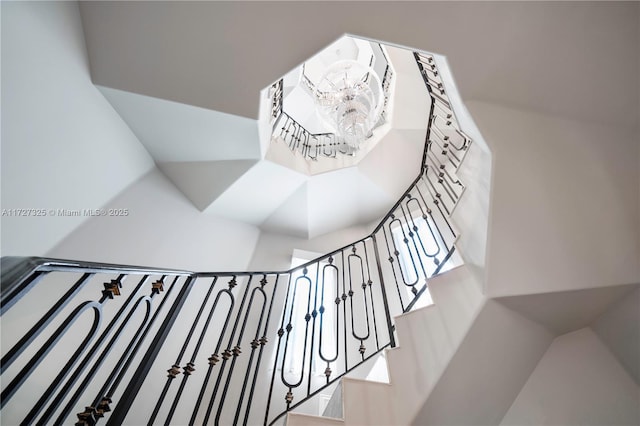 staircase featuring a chandelier