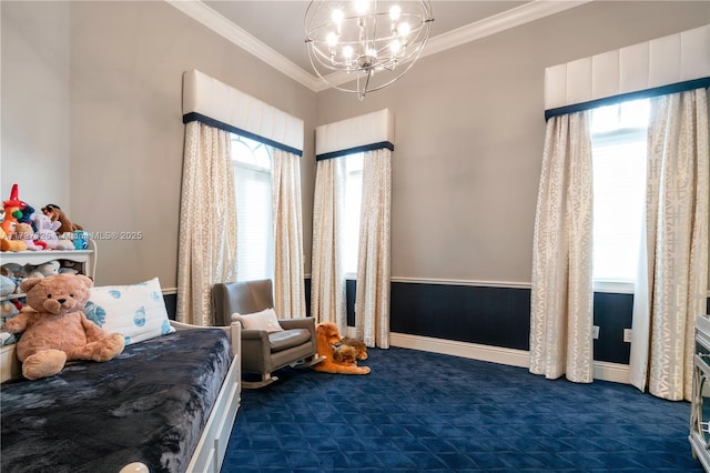 carpeted bedroom featuring multiple windows, crown molding, and an inviting chandelier