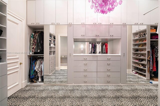 bathroom with vanity, a towering ceiling, independent shower and bath, and a chandelier