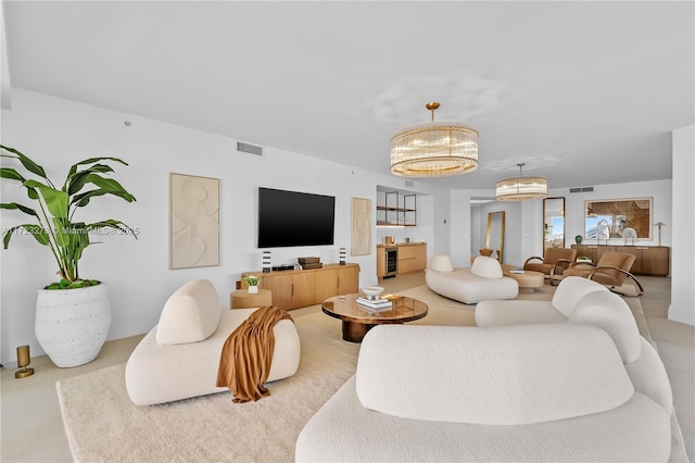 living room featuring wine cooler and a notable chandelier