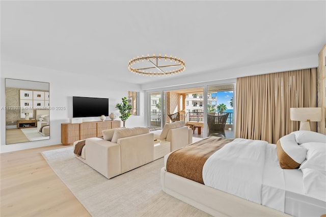 bedroom featuring hardwood / wood-style floors and access to outside