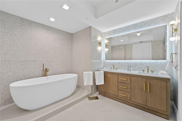 bathroom featuring vanity and a tub to relax in