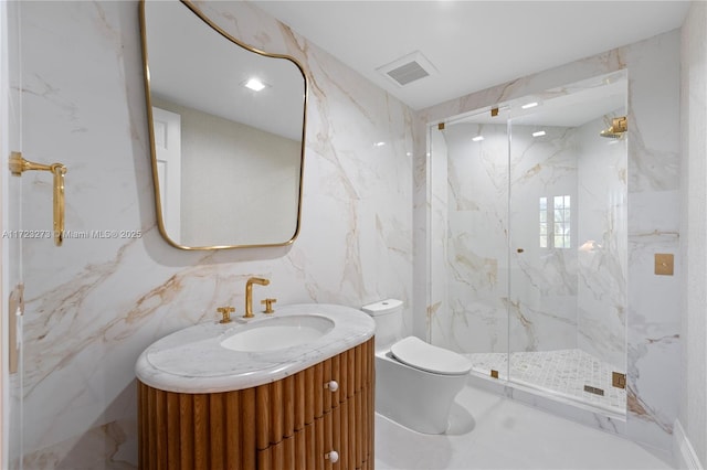 bathroom with vanity, toilet, a shower with shower door, and tile walls