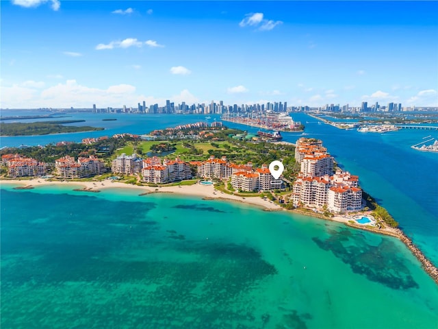 birds eye view of property featuring a water view and a beach view