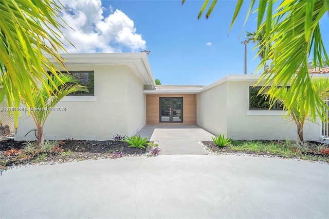 property entrance with french doors and a patio