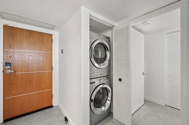 laundry area with stacked washer and clothes dryer