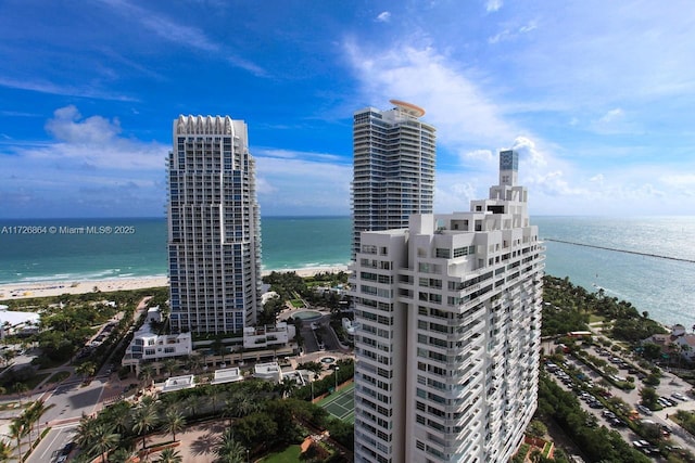 exterior space featuring a water view and a beach view