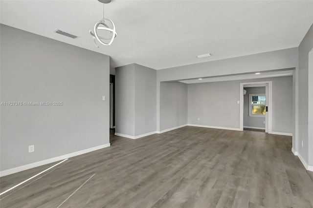 unfurnished room with dark hardwood / wood-style flooring