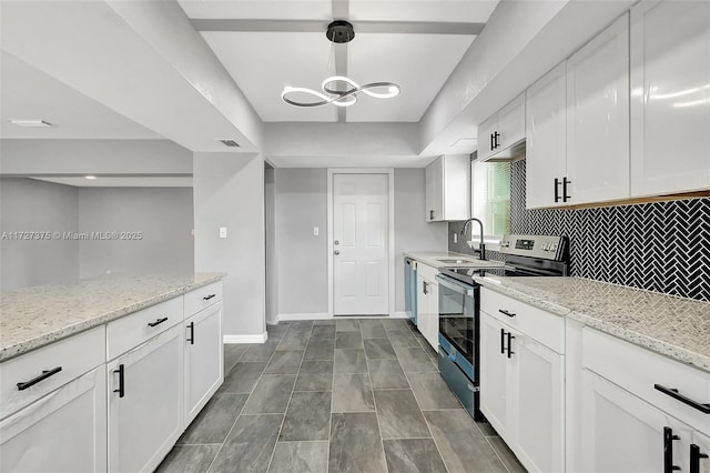 kitchen featuring stainless steel electric stove, light stone countertops, pendant lighting, white cabinets, and sink