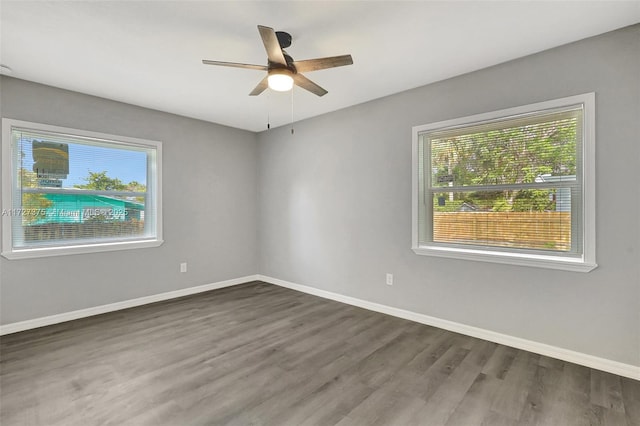 empty room featuring ceiling fan and dark hardwood / wood-style floors