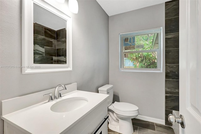 bathroom featuring toilet, vanity, and tile patterned floors