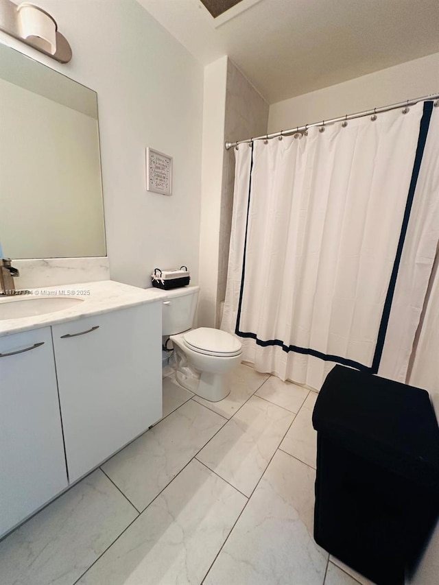 bathroom featuring toilet and vanity