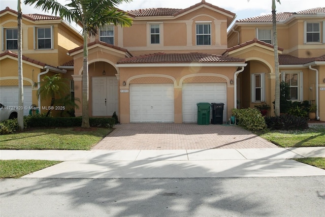 mediterranean / spanish house with a garage