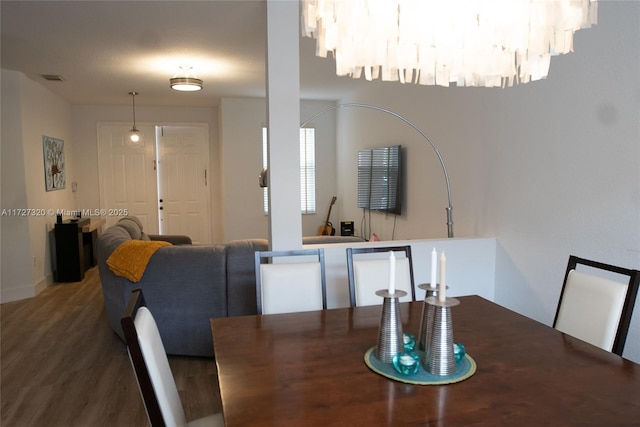 dining space with a chandelier and hardwood / wood-style floors