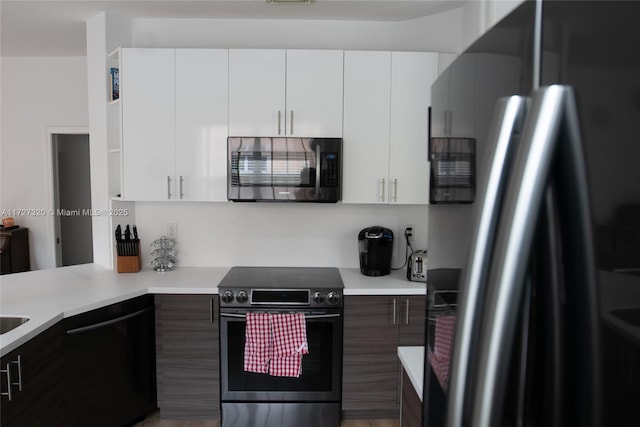 kitchen with appliances with stainless steel finishes, white cabinetry, and dark brown cabinetry