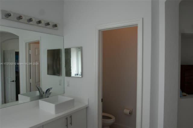 bathroom featuring toilet and vanity