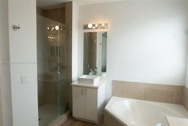 bathroom with shower with separate bathtub and vanity