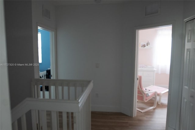 bedroom featuring a crib and hardwood / wood-style flooring