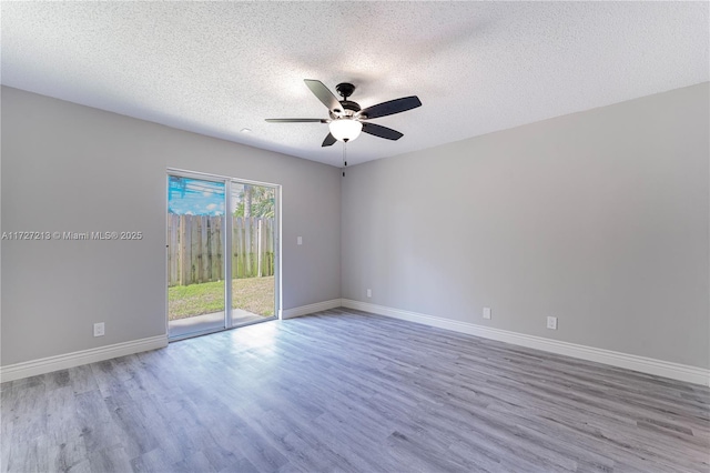 empty room featuring ceiling fan, a textured ceiling, and hardwood / wood-style flooring