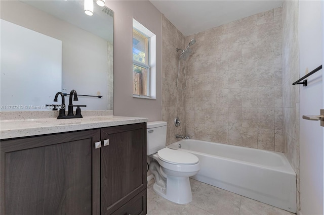 full bathroom featuring toilet, tiled shower / bath combo, tile patterned flooring, and vanity