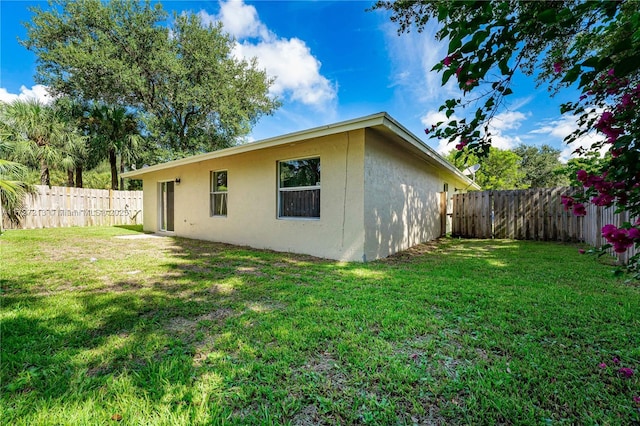 rear view of property featuring a lawn