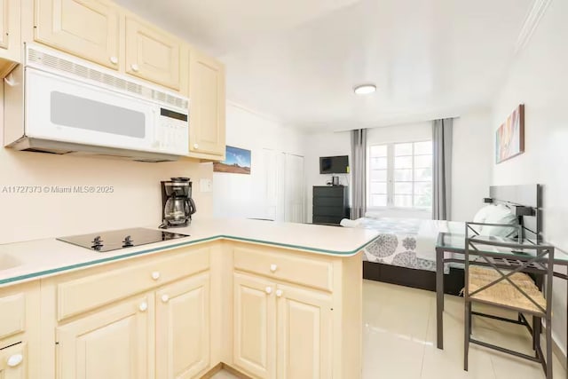 kitchen featuring light tile patterned floors, black electric stovetop, kitchen peninsula, and cream cabinetry