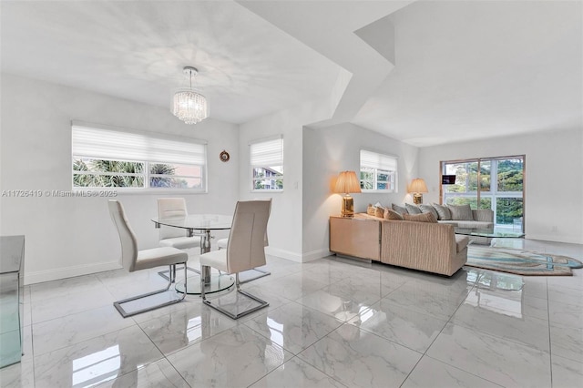 dining area featuring plenty of natural light and a notable chandelier