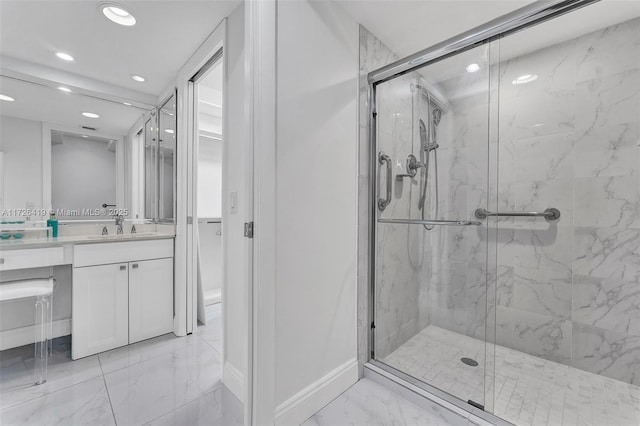 bathroom with a shower with door and vanity