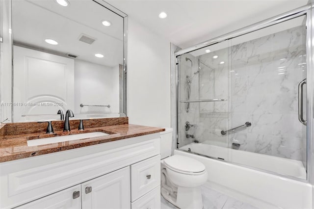 full bathroom featuring toilet, vanity, and shower / bath combination with glass door