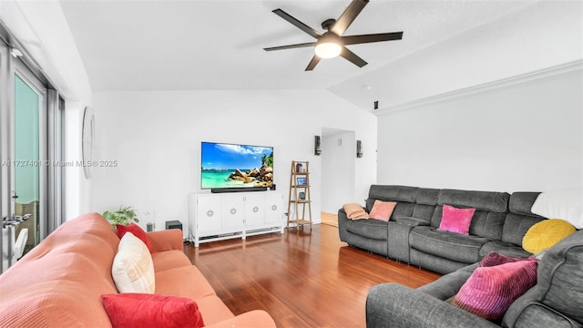 living room with ceiling fan, vaulted ceiling, and hardwood / wood-style flooring