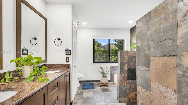 bathroom featuring toilet and vanity