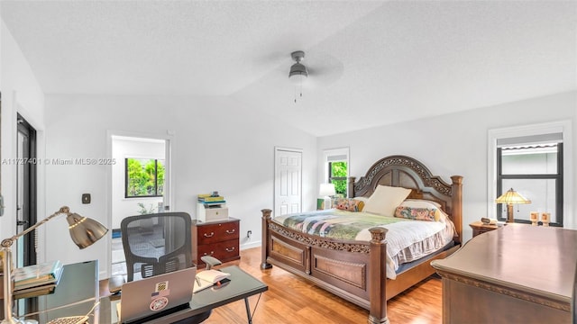 bedroom featuring ceiling fan, a closet, multiple windows, and light hardwood / wood-style floors