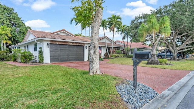 single story home featuring a front yard and a garage