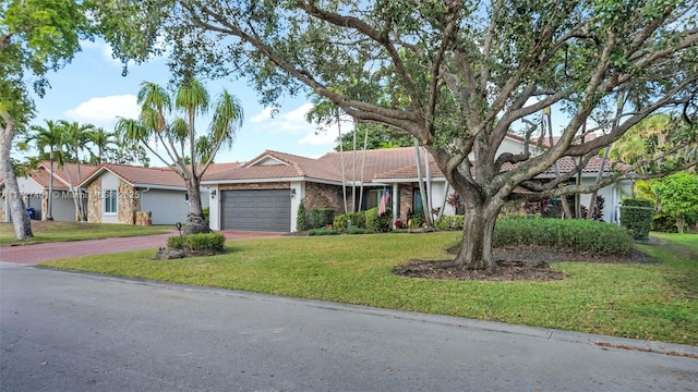 single story home with a front yard and a garage