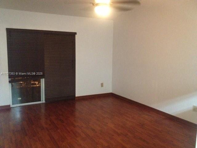 unfurnished room featuring ceiling fan and dark hardwood / wood-style flooring