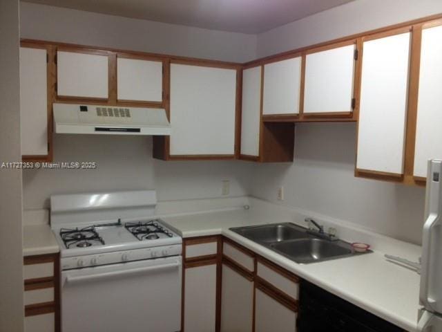 kitchen featuring exhaust hood, white cabinetry, and white gas range