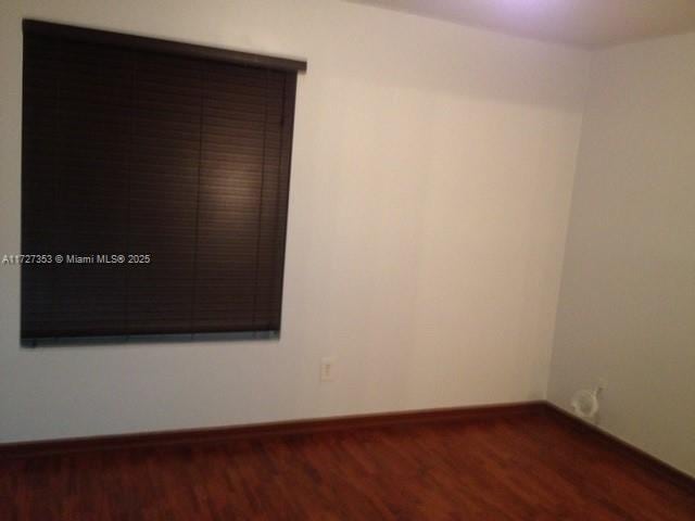 spare room featuring dark hardwood / wood-style floors