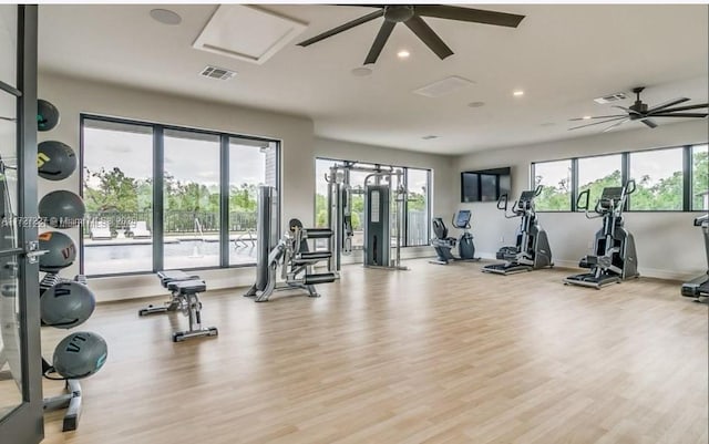 workout area featuring light wood finished floors, ceiling fan, visible vents, and recessed lighting