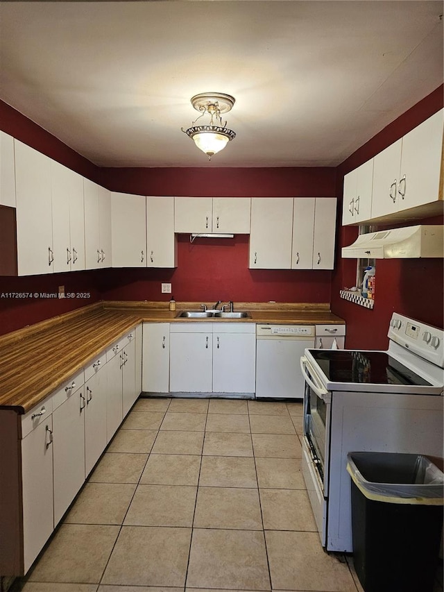 kitchen featuring white cabinetry, sink, light tile patterned floors, and white appliances