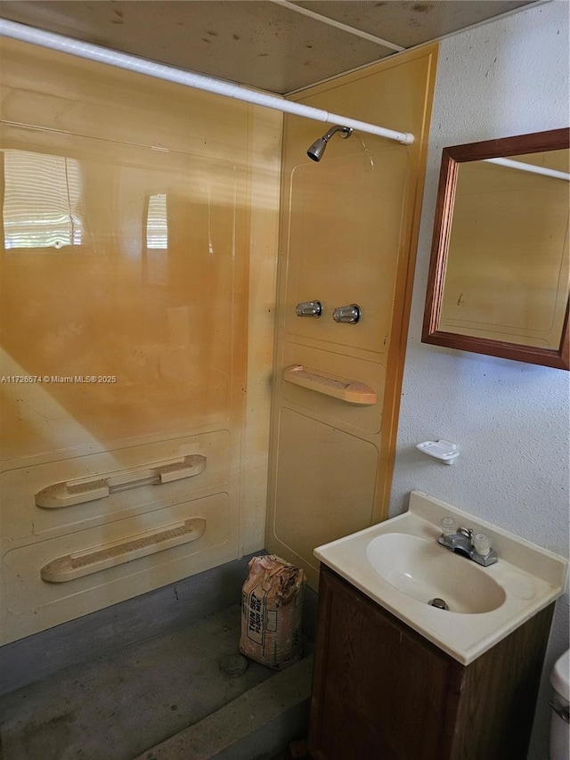 bathroom with vanity, toilet, and walk in shower